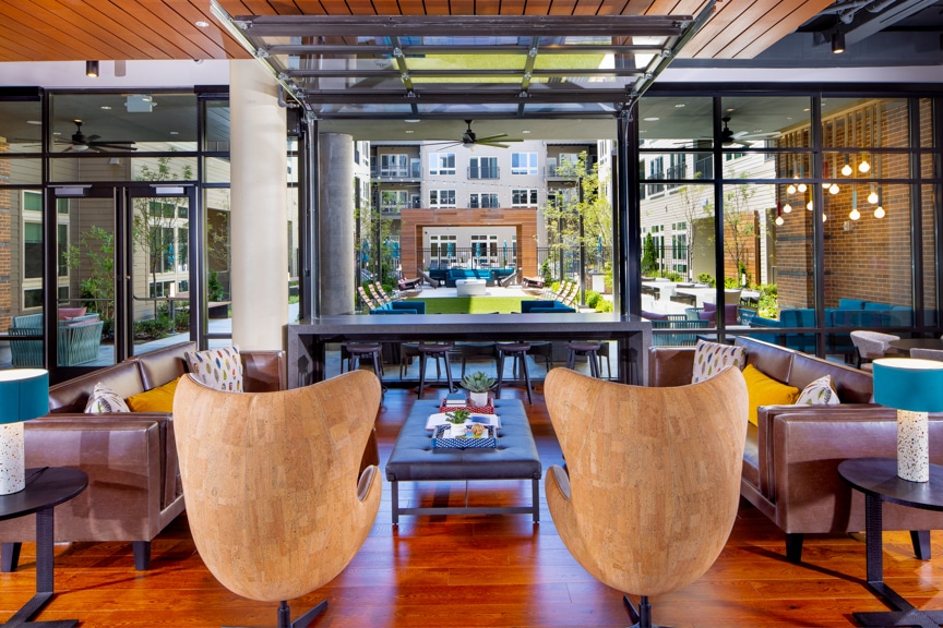 Clubroom lounge with open window to indoor/outdoor bar area and courtyard - South Alex luxury apartments Alexandria VA