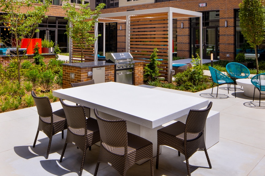 Outdoor kitchen with grilling station and seating areas - South Alex luxury apartments Alexandria VA
