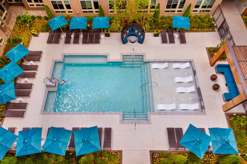 aerial view of swimming pool, umbrellas and seating