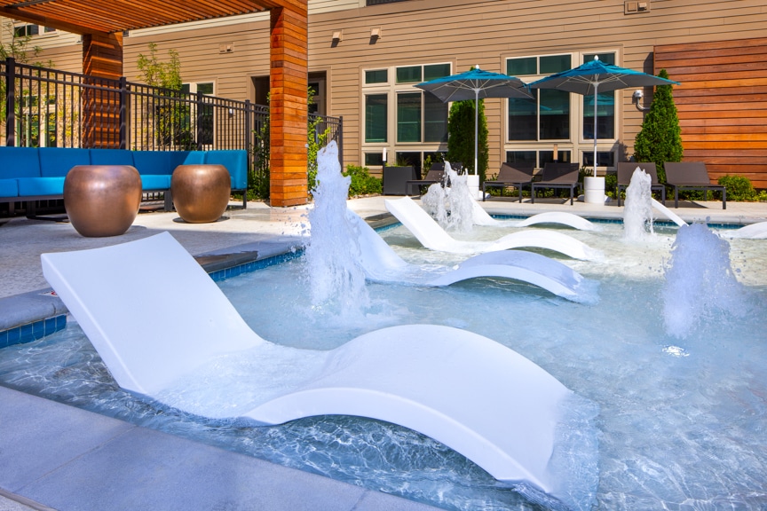 pool water feature with immersed chaises