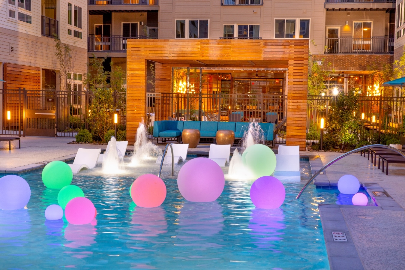 swimming pool at night with lit balls floating - south alex luxury apartments alexandria va