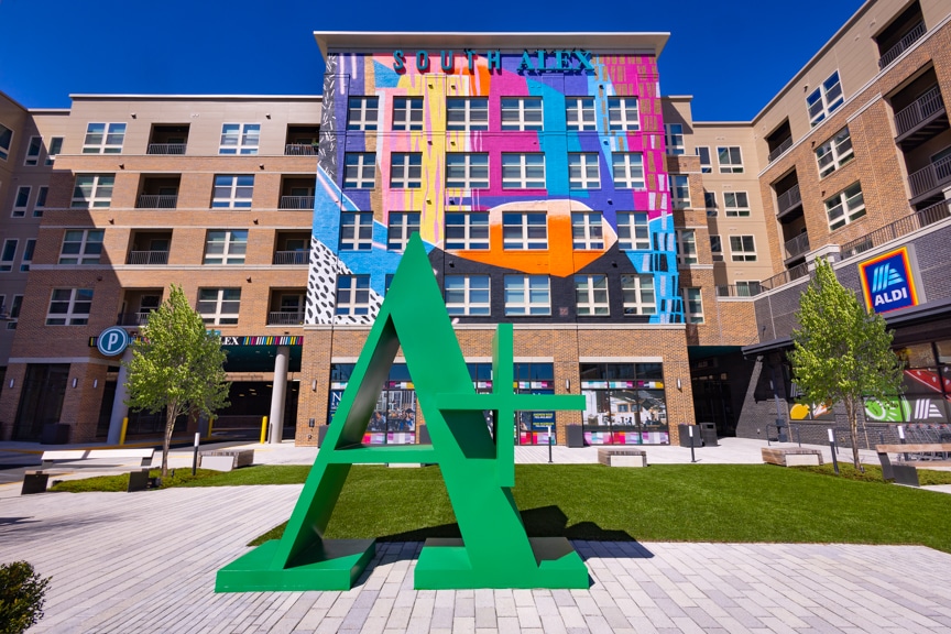 plaza with sculpture and building with mural - alexandria va luxury apartments south alex